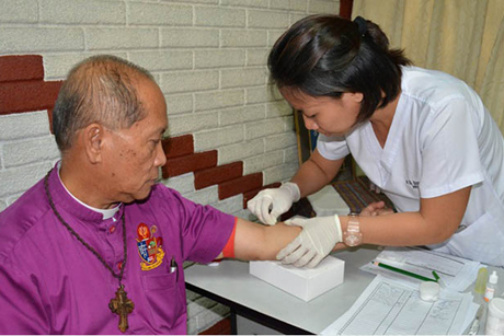 The Most Revd Ephraim S Fajutagana, Supreme Bishop of the Philippine Independent Church, undergoes an HIV test as part of the National Council of Churches in the Philippines public campaign to remove the stigma associated with HIV/Aids.
